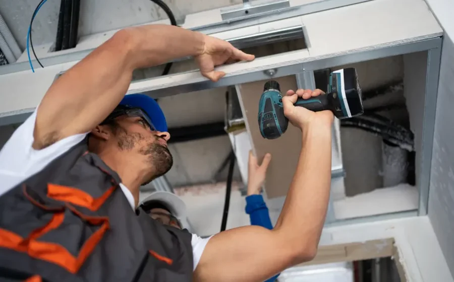 HVAC technician checking equipment during an emergency diagnostic visit