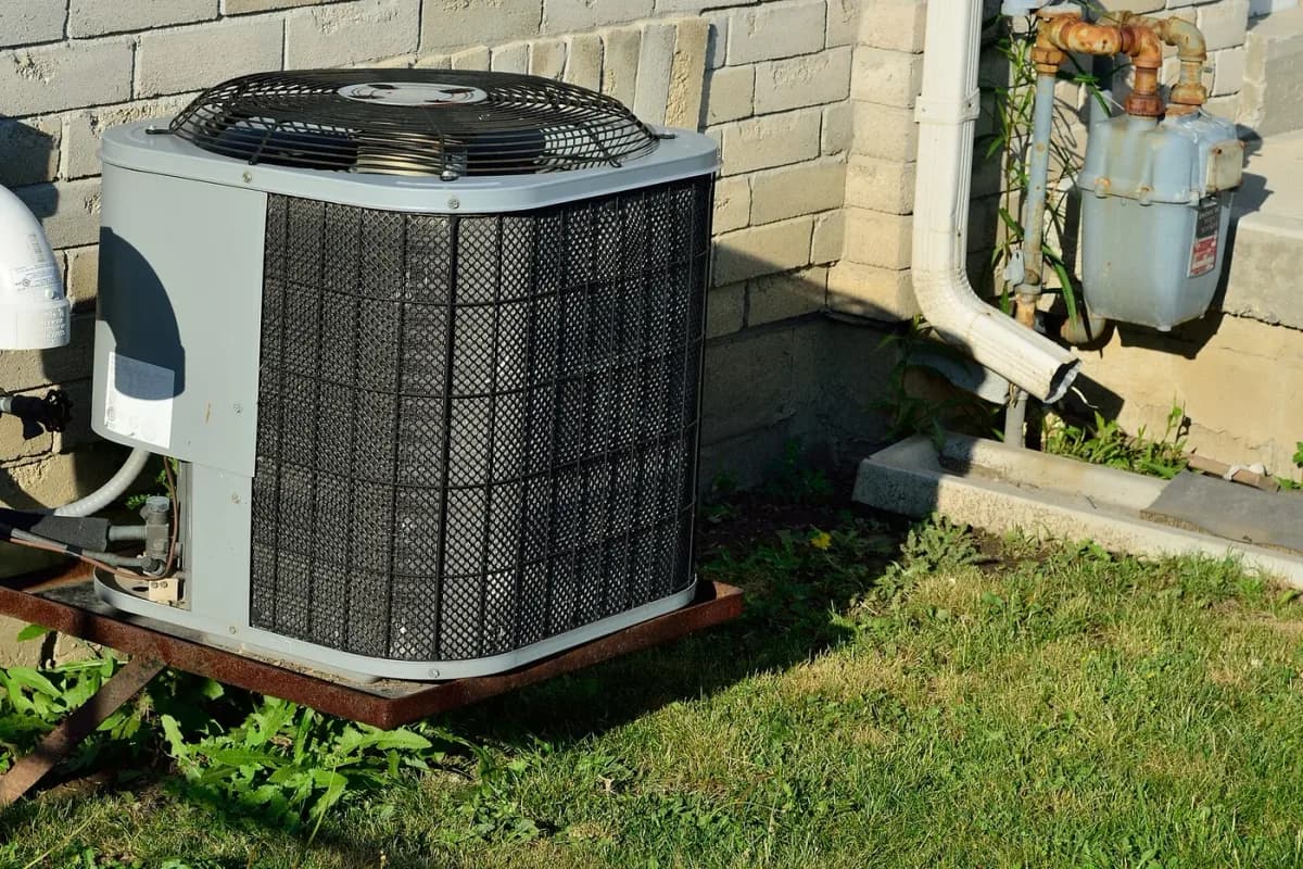 Outdoor condenser beside a building, showing the space needed for outdoor heating or cooling equipment