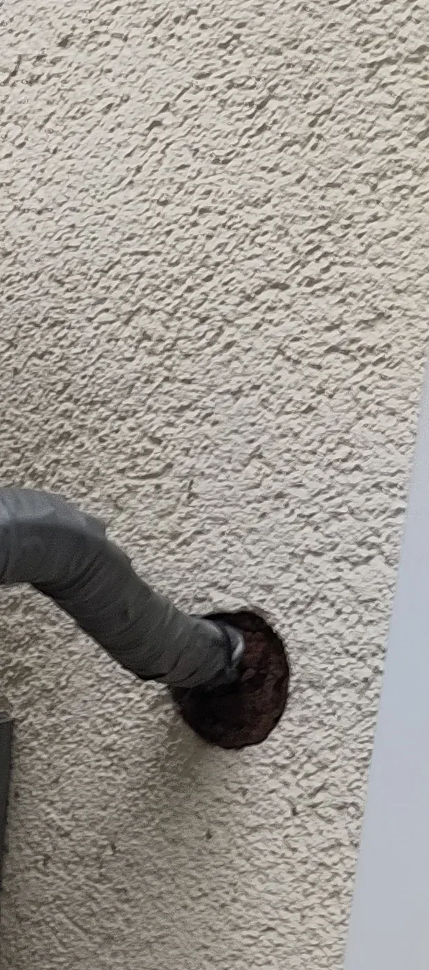 Insulated connection from a split-system outdoor unit entering an exterior wall